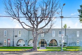 Canoga Park apartment for rent - A tree in front of a building with the number 724 on it.
