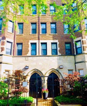 Chicago apartment for rent - a large brick building with a black gate in front of it