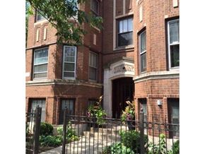 Chicago apartment for rent - a brick apartment building with a wrought iron fence