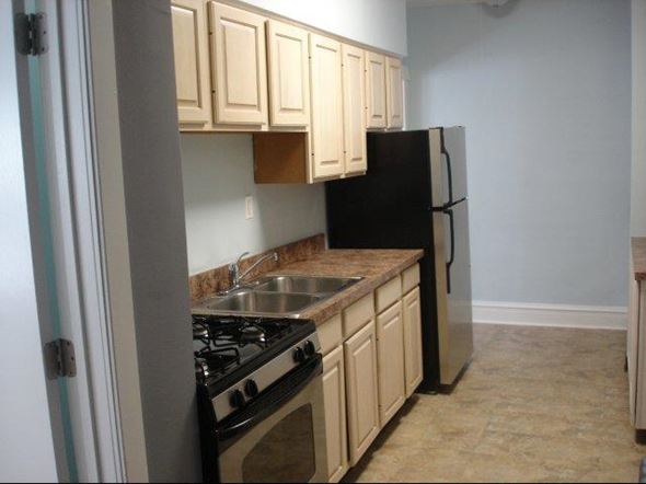 Chicago apartment for rent - a small kitchen with a stove and a refrigerator