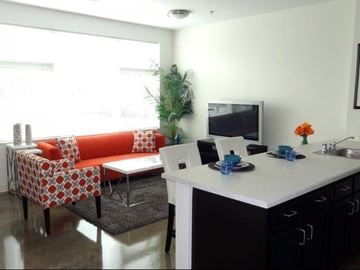 Chicago apartment for rent - a living room with an orange couch and a table
