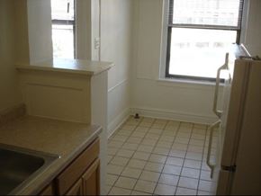 Chicago apartment for rent - an empty kitchen with a sink and a window