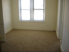 Chicago apartment for rent - an empty room with a window and a carpet