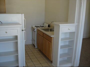 Chicago apartment for rent - a kitchen with a sink and a stove and a refrigerator