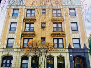 Chicago apartment for rent - a tall building with a tree in front of it