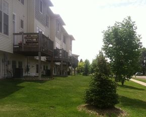 Faribault townhouse for rent - a view of the back of a house with a deck