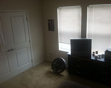 Faribault townhouse for rent - a living room with a tv and a door and two windows