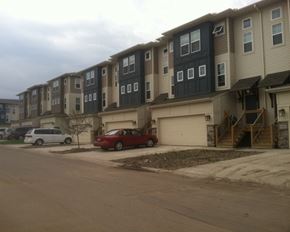 Faribault townhouse for rent - an apartment building on a street with cars parked in front