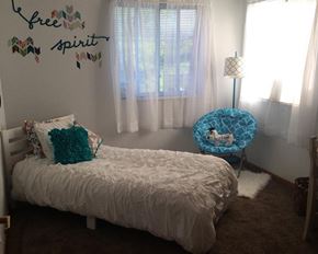 Jackson townhouse for rent - a small bedroom with a bed and a chair