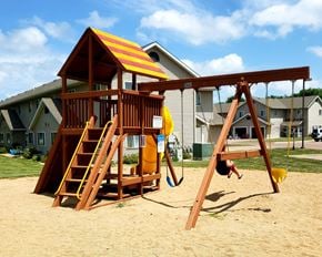 Luverne townhouse for rent - a child playing on a swing set in a playground