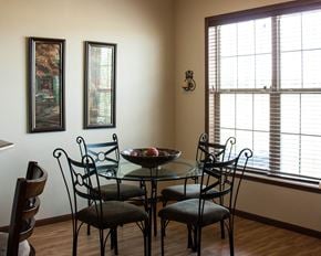 Northfield townhouse for rent - a dining room with a glass table and chairs and two windows