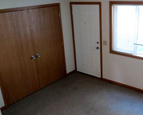 Luverne townhouse for rent - a bedroom with a door and a window