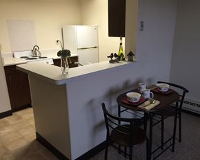 Pipestone apartment for rent - a kitchen with a counter and a table with chairs