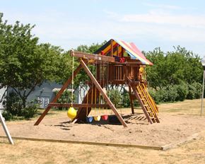 Pipestone apartment for rent - a swing set in a backyard playground