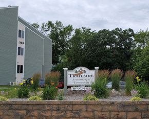 Albert Lea townhouse for rent - the sign for trailside apartments at the entrance of the building