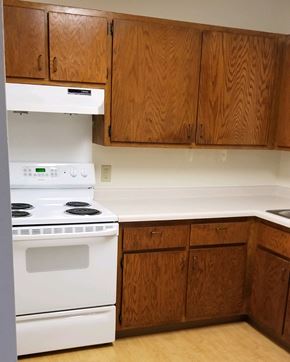 Silver Lake apartment for rent - an empty kitchen with white appliances and wooden cabinets