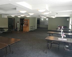 Buffalo apartment for rent - an empty room with tables and chairs in a room