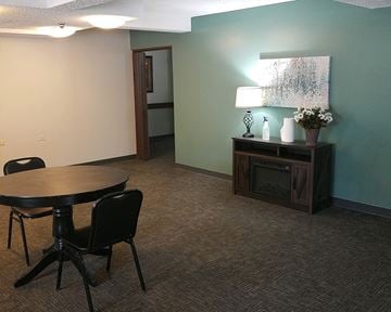 Buffalo apartment for rent - a living room with a table and a fire place