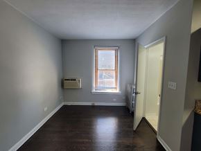 Chicago apartment for rent - a living room with wood floors and a window