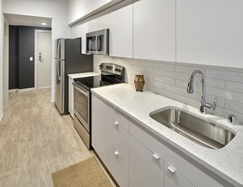 Glossy kitchen cabinets in white or navy blue, along with porcelain tile backsplashes