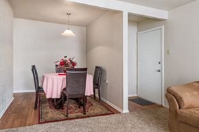 Lafayette apartment for rent - a dining room with a table with a pink table cloth and a couch