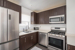 Roslyn apartment for rent - a kitchen with stainless steel appliances and wooden cabinets