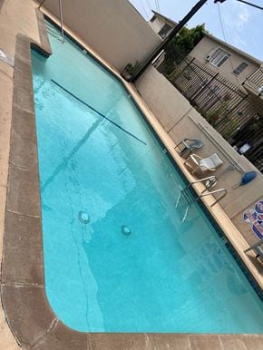 Los Angeles apartment for rent - a large swimming pool in front of a building