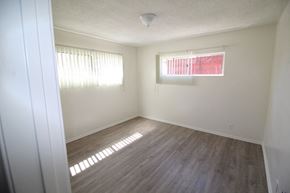 Los Angeles apartment for rent - an empty room with wooden floors and a window