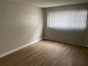 Los Angeles apartment for rent - an empty living room with wood floors and a large window