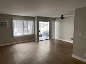 Los Angeles apartment for rent - an empty living room with wood floors and a sliding glass door