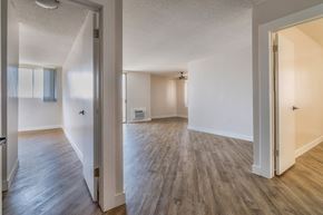 Los Angeles apartment for rent - an open living room and dining room with wood flooring and white walls