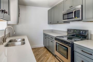 Los Angeles apartment for rent - a kitchen with stainless steel appliances and white counter tops
