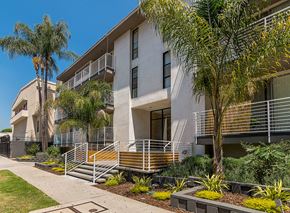 Los Angeles apartment for rent - an apartment building with palm trees in front of it