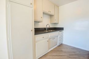 Los Angeles apartment for rent - an empty kitchen with white cabinets and a sink