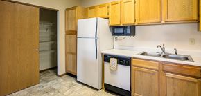Ada apartment for rent - a kitchen with a white refrigerator and a sink
