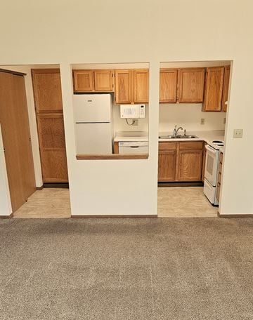 Erskine apartment for rent - A kitchen with a white refrigerator and wooden cabinets.