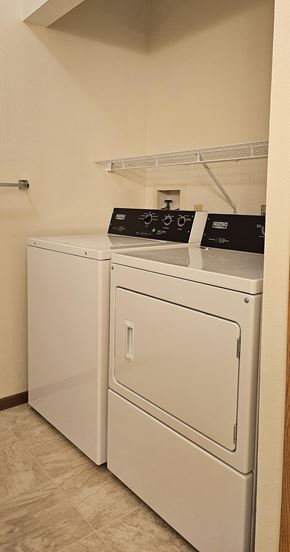 Erskine apartment for rent - A white washing machine and dryer in a laundry room.