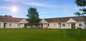 Fosston apartment for rent - A sunny day at a residential area with houses and green lawns.