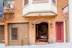 San Francisco apartment for rent - A red door is on the right side of a building.