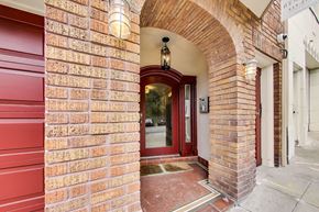 San Francisco apartment for rent - A red brick building with a white door and a sign that reads "RE1 11:27".