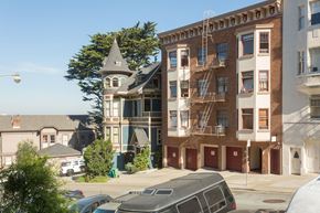 San Francisco apartment for rent - A large building with a tower sits next to a parking lot.