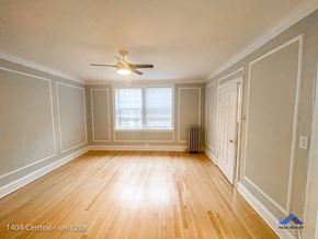Evanston apartment for rent - the living room of a home with wood floors and a ceiling fan