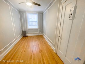 Evanston apartment for rent - an empty room with wood floors and white walls and a window