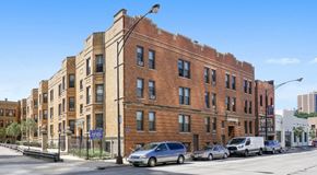 Chicago apartment for rent - a large brick building on a city street with cars