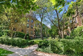 Evanston apartment for rent - a sidewalk in a park with trees and buildings