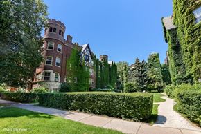 Evanston apartment for rent - a sidewalk in front of a building with trees and bushes