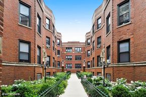 Chicago apartment for rent - a city street with red brick buildings and a sidewalk