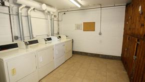 Chicago apartment for rent - a laundry room with several sinks and white appliances