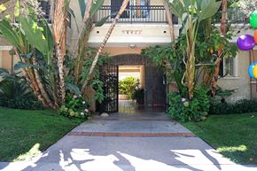 Northridge apartment for rent - A gate with a metal railing and a house number 1402 above it.
