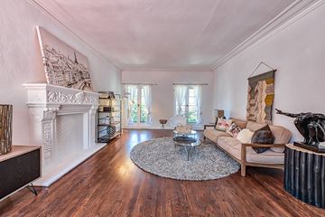 Hollywood apartment for rent - a living room with a couch and a fireplace